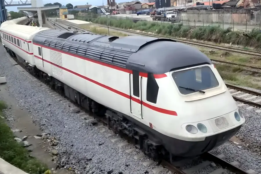A high speed train in Lagos Red Line livery standing at a station on the mainland