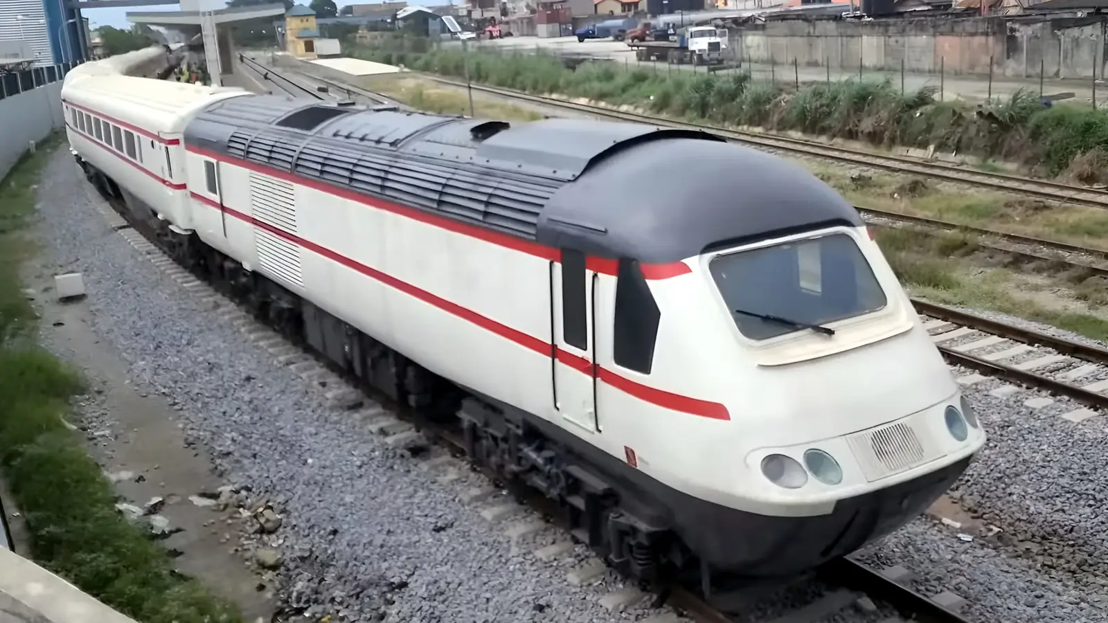 A high speed train in Lagos Red Line livery standing at a station on the mainland